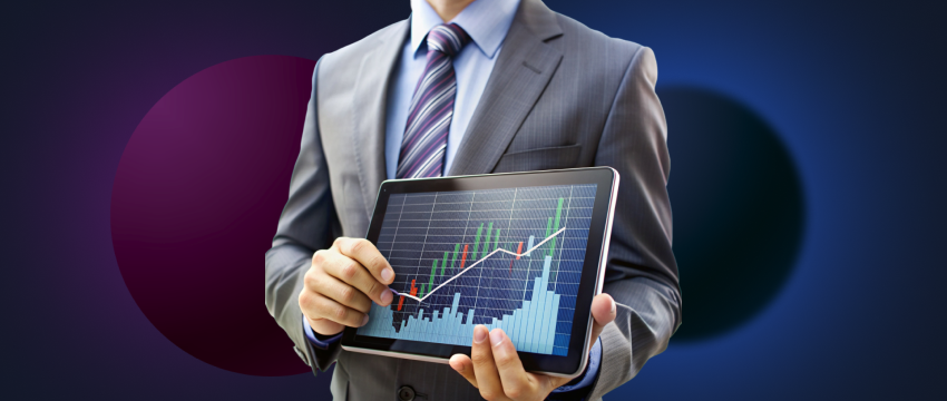 3. A man dressed in a suit analyzes a graph on a tablet, illustrating key strategies for successful day traders