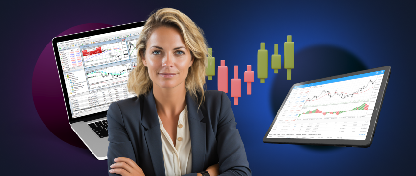 A woman in a business suit reviews trading charts on her laptop and computer screen, focused on commodities analysis.